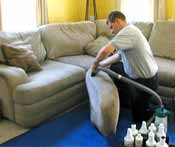 Man cleaning upholstery.